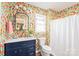 Bright bathroom features floral wallpaper, a modern vanity with countertop sink, and a shower with white curtain at 618 Heathermoor Ct, Charlotte, NC 28209