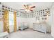 Bright Bedroom featuring an accent wall, a crib, and a gray changing table with carpet floors at 618 Heathermoor Ct, Charlotte, NC 28209