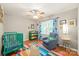 Cozy bedroom featuring a green crib, a sitting chair, and a colorful rug on hardwood floors at 618 Heathermoor Ct, Charlotte, NC 28209