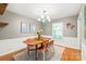 Dining room featuring a wooden table, chairs, and a large window with natural light at 618 Heathermoor Ct, Charlotte, NC 28209