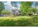 Charming two-story home with a green lawn and well-kept garden beds enhancing the curb appeal of the property at 618 Heathermoor Ct, Charlotte, NC 28209