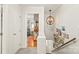 Bright hallway with a unique light fixture and view into the living room with hardwood floors at 618 Heathermoor Ct, Charlotte, NC 28209
