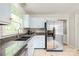 Modern kitchen featuring stainless steel appliances, granite countertops, and ample cabinet space for storage at 618 Heathermoor Ct, Charlotte, NC 28209