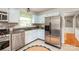 Well-appointed kitchen with stainless steel appliances, sleek countertops, and tiled backsplash at 618 Heathermoor Ct, Charlotte, NC 28209