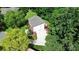 Aerial view of a two-story home with a long driveway, attached garage, and lush, mature trees at 655 Powder Horn Ln, Indian Trail, NC 28079