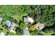 Aerial view of the property showcasing its location, landscaping, and proximity to surrounding trees at 655 Powder Horn Ln, Indian Trail, NC 28079