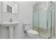 Cozy bathroom featuring a pedestal sink, toilet, and a glass-enclosed shower for a clean and functional design at 655 Powder Horn Ln, Indian Trail, NC 28079
