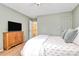 Comfortable bedroom boasts a TV, light hardwood floors and calm paint color at 655 Powder Horn Ln, Indian Trail, NC 28079