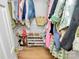 Organized walk-in closet with shelves for shoes and clothes, maximizing storage space efficiently at 655 Powder Horn Ln, Indian Trail, NC 28079