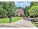 Charming two-story brick home with a well-kept lawn, mature landscaping, and a long driveway at 655 Powder Horn Ln, Indian Trail, NC 28079