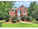 Attractive two-story brick home with a well-maintained lawn and beautifully trimmed shrubs at 655 Powder Horn Ln, Indian Trail, NC 28079
