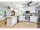 Bright, modern kitchen with stainless steel appliances, a spacious island, and stylish pendant lighting at 655 Powder Horn Ln, Indian Trail, NC 28079