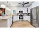 Well-lit kitchen featuring stainless steel appliances, white cabinets, and sleek countertops for a contemporary feel at 655 Powder Horn Ln, Indian Trail, NC 28079