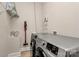 Functional laundry room with modern washer and dryer, shelving, and ample storage space at 655 Powder Horn Ln, Indian Trail, NC 28079