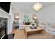 Inviting living room with a cozy fireplace, stylish chandelier, and large windows for natural light at 655 Powder Horn Ln, Indian Trail, NC 28079