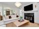 Open-concept living room featuring a fireplace, mounted TV, and sophisticated decor for a comfortable atmosphere at 655 Powder Horn Ln, Indian Trail, NC 28079