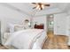 Primary bedroom featuring tray ceilings, hardwood floors, natural light and ensuite bath access at 655 Powder Horn Ln, Indian Trail, NC 28079