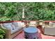 Secluded outdoor deck with comfortable seating and a lush green backdrop at 655 Powder Horn Ln, Indian Trail, NC 28079