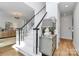 Bright staircase with white risers and dark handrail at 655 Powder Horn Ln, Indian Trail, NC 28079