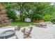 Inviting patio space with outdoor dining set, fire pit, and lounge area at 6621 Ronda Ave, Charlotte, NC 28211