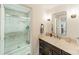 Modern bathroom boasts a glass enclosed shower with beautiful white tile and contemporary vanity at 6621 Ronda Ave, Charlotte, NC 28211