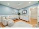 Charming Bedroom with soft blue walls, hardwood floors, and a cozy armchair at 6621 Ronda Ave, Charlotte, NC 28211