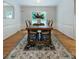 Charming dining room featuring a wood table, seating for six, and french doors at 6621 Ronda Ave, Charlotte, NC 28211