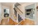 Inviting foyer featuring hardwood floors, staircase, and views into other rooms at 6621 Ronda Ave, Charlotte, NC 28211