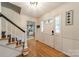 Welcoming foyer with hardwood floors, staircase, and ample natural light at 6621 Ronda Ave, Charlotte, NC 28211