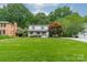 Beautifully landscaped front yard enhances this two-story home's curb appeal at 6621 Ronda Ave, Charlotte, NC 28211