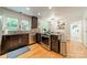 Modern kitchen features stainless steel appliances, granite countertops and beautiful wood floors at 6621 Ronda Ave, Charlotte, NC 28211