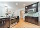Modern kitchen with stainless steel appliances, mosaic backsplash, and hardwood flooring at 6621 Ronda Ave, Charlotte, NC 28211