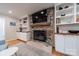 Cozy living room featuring a stone fireplace, TV, and custom built-in shelving at 6621 Ronda Ave, Charlotte, NC 28211