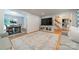Open-concept living area with views into dining and staircase, plus hardwood floors at 6621 Ronda Ave, Charlotte, NC 28211