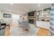 Inviting living room with a stone fireplace, built-in shelving, and hardwood floors at 6621 Ronda Ave, Charlotte, NC 28211