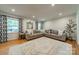 Spacious living room featuring hardwood floors and large windows with patterned curtains at 6621 Ronda Ave, Charlotte, NC 28211