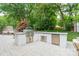 Modern outdoor kitchen with stainless steel appliances and countertop seating at 6621 Ronda Ave, Charlotte, NC 28211