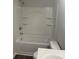 Bright bathroom featuring a white tub and shower combo with built-in shelving at 7 Scott Sw St, Concord, NC 28025
