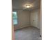 Bedroom featuring neutral walls, carpet flooring, closet, and window at 7 Scott Sw St, Concord, NC 28025