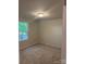 Bedroom featuring neutral walls, carpet flooring, and a window at 7 Scott Sw St, Concord, NC 28025