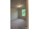 Bedroom featuring neutral walls, carpet flooring, and a window at 7 Scott Sw St, Concord, NC 28025