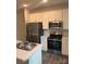 Modern kitchen with stainless steel appliances, white cabinets, and plenty of counter space for food preparation at 7 Scott Sw St, Concord, NC 28025