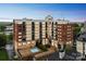Multi-story building with brick and stucco accents featuring balconies and a pool at 715 N Church St # 613, Charlotte, NC 28202