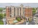 A multi-story building features brick and stucco accents, balconies, a pool, and modern outdoor art at 715 N Church St # 613, Charlotte, NC 28202