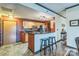 Modern kitchen with breakfast bar seating, stainless appliances, granite countertops, and ample storage at 715 N Church St # 613, Charlotte, NC 28202