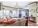 Open-concept living room with hardwood floors, neutral sofa, and sliding door access to a balcony at 715 N Church St # 613, Charlotte, NC 28202