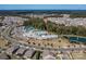 Aerial view of a community with a pool, clubhouse, parking, tennis courts and pond at 7332 Jolly Brook Dr, Charlotte, NC 28215