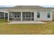 Screened in back porch with a paved yard, and fence overlooking green grass at 7332 Jolly Brook Dr, Charlotte, NC 28215