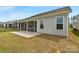 View of screened in back porch overlooking green grass with an irrigation ditch nearby at 7332 Jolly Brook Dr, Charlotte, NC 28215
