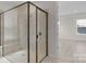 Shower with frameless glass door and tile surround, adjacent to a doorway to another room at 7332 Jolly Brook Dr, Charlotte, NC 28215
